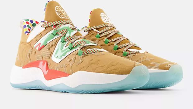 View of brown and green New Balance shoe.